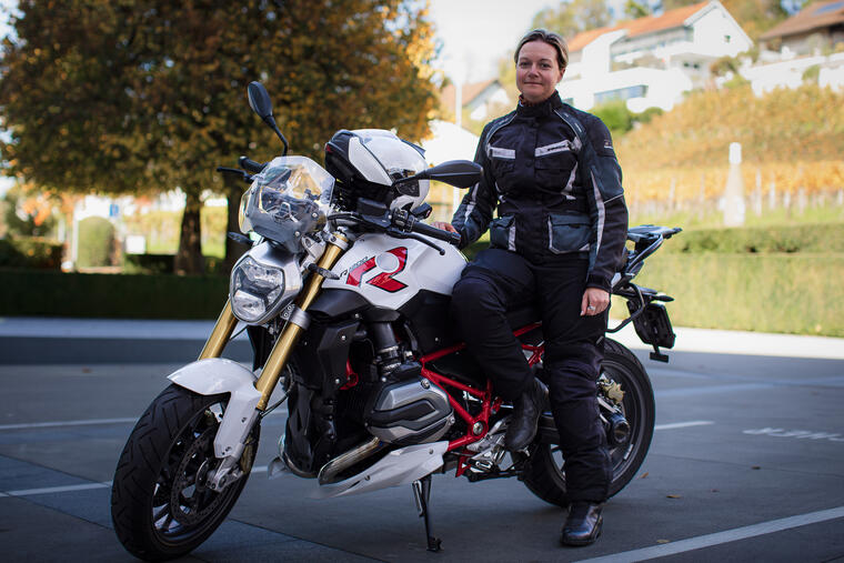 Women sits on a motorbike