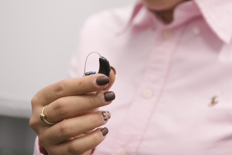 Woman holding a hearing instrument 