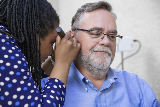 Audiologist examining patient