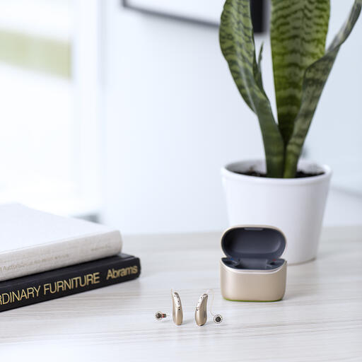 Phonak Cros Lifestyle on a desk in front of a plant