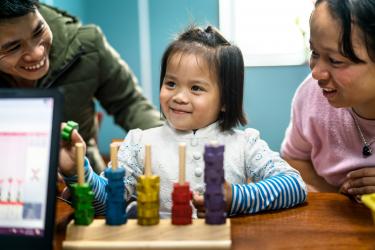 A girl in Vietnam with a cochlear implant doing play audiometry