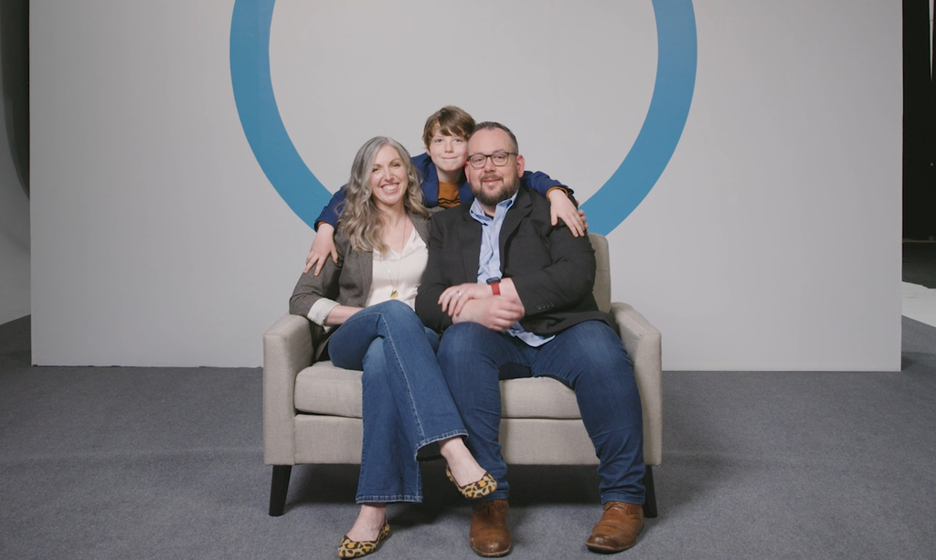 A family sitting on a sofa